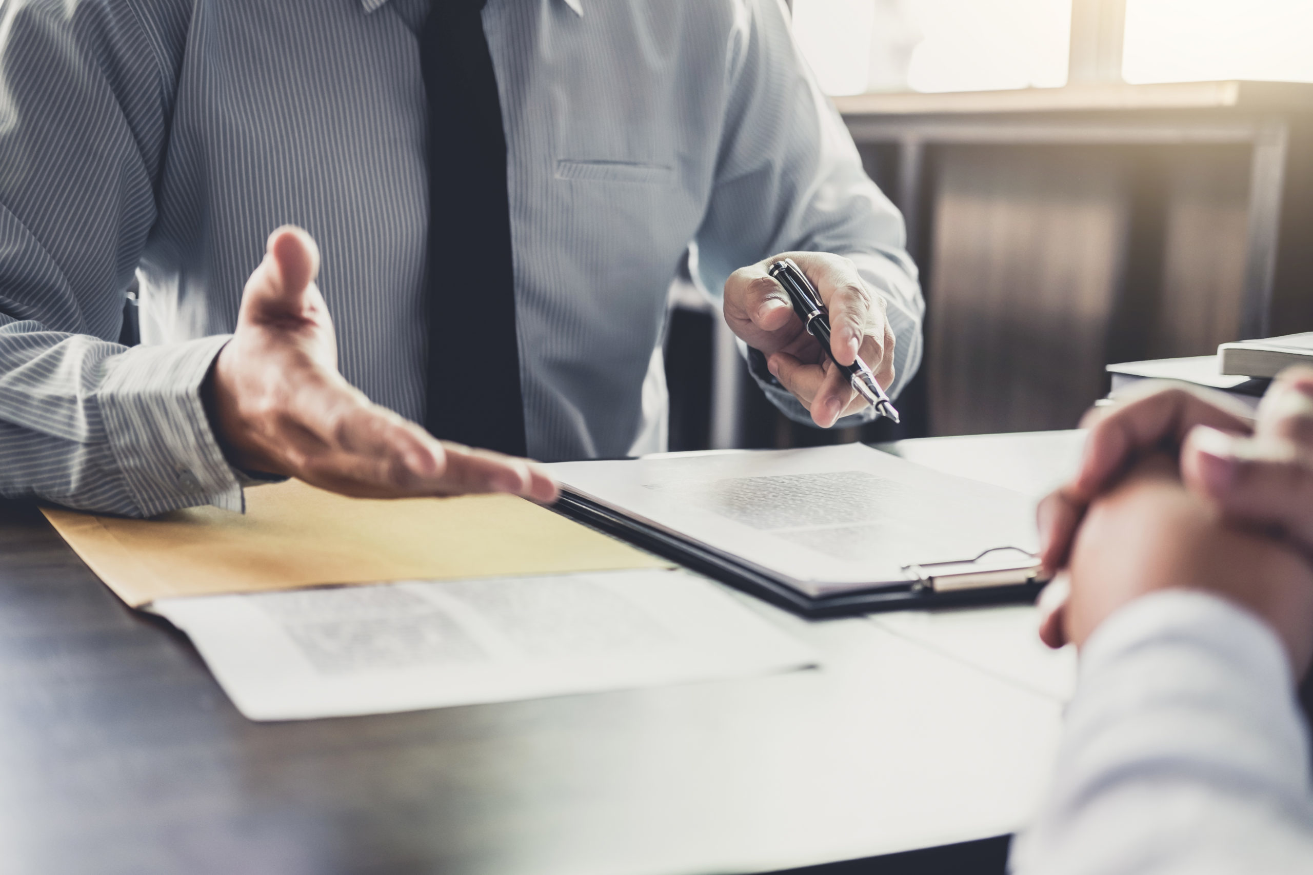 Businessman,And,Male,Lawyer,Or,Judge,Consult,Having,Team,Meeting Meeting with paperwork