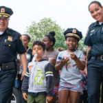 Police officers walking with kids