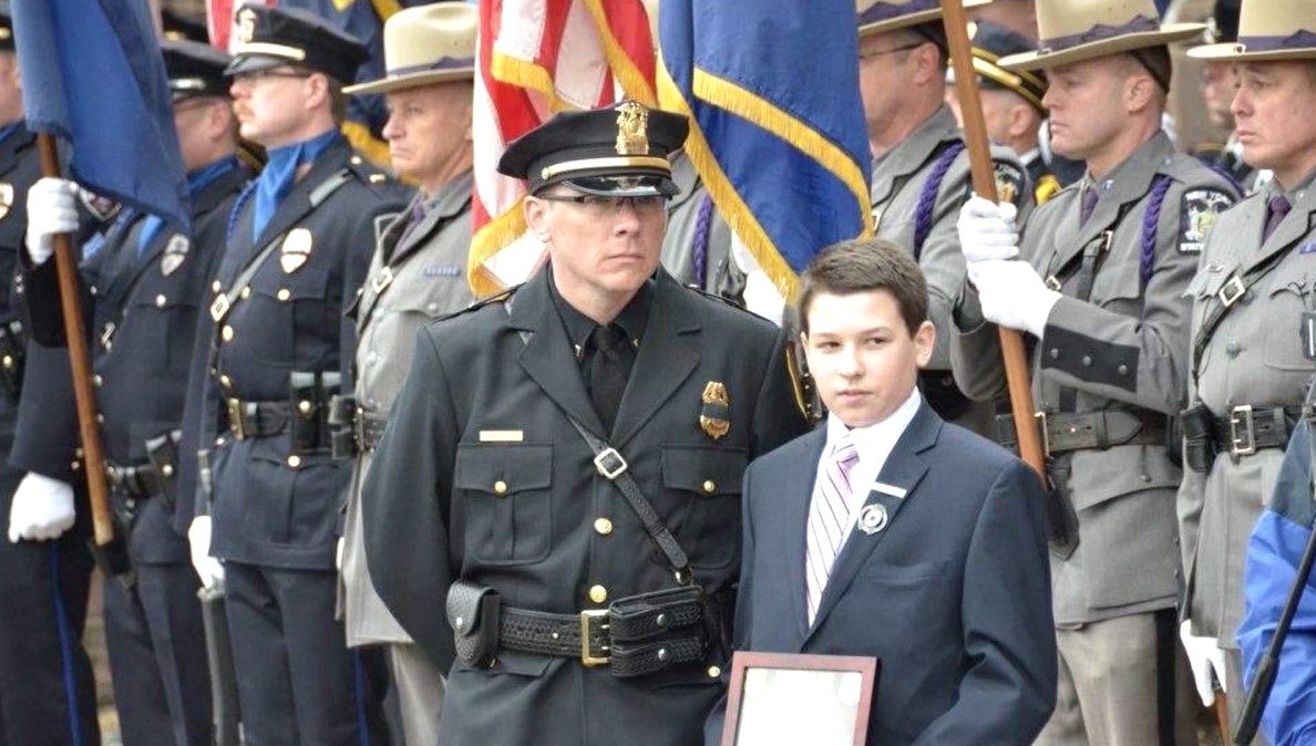 Lieutenant Mike Hatch with Officer Smith's son Lieutenant Mike Hatch with Officer Smith's son, 2014