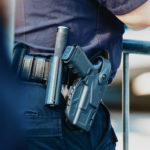 Manhattan 2019. Behind the police with gun belt, close up